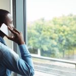 Business executive talking on mobile phone in office